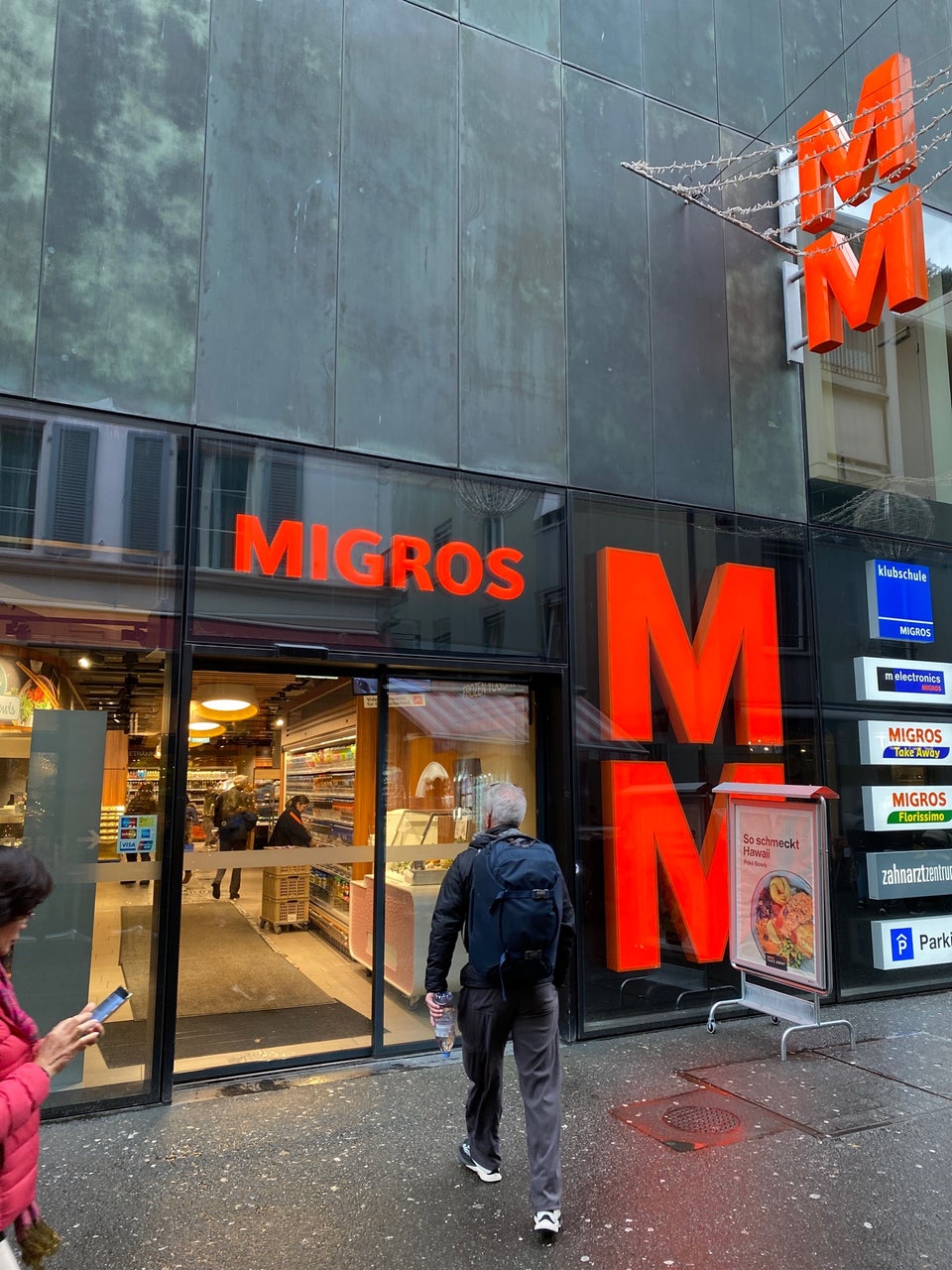 Migros supermarket exterior in Switzerland — the orange M logo